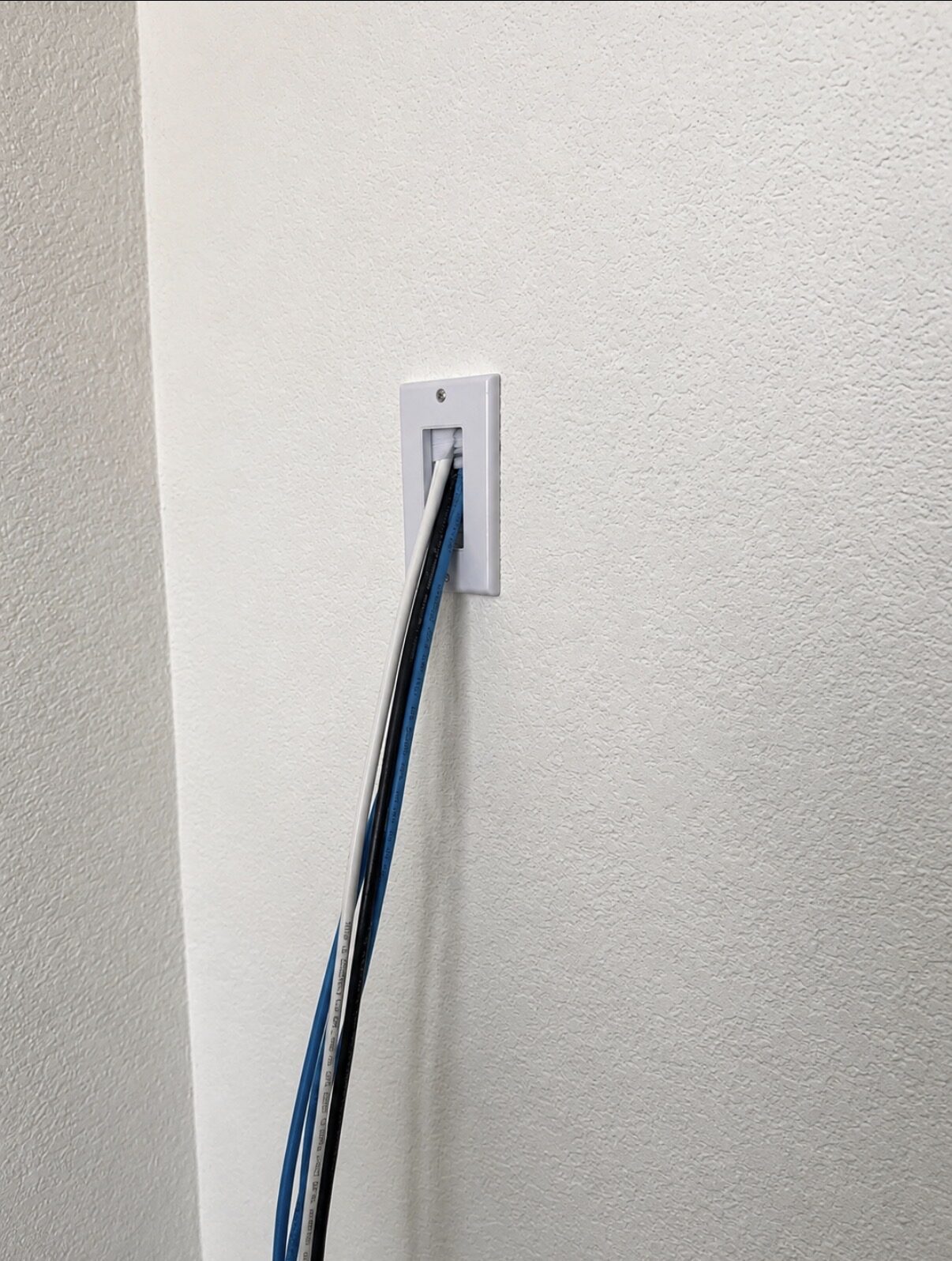 Clean cable pass-through for a wall-mounted TV